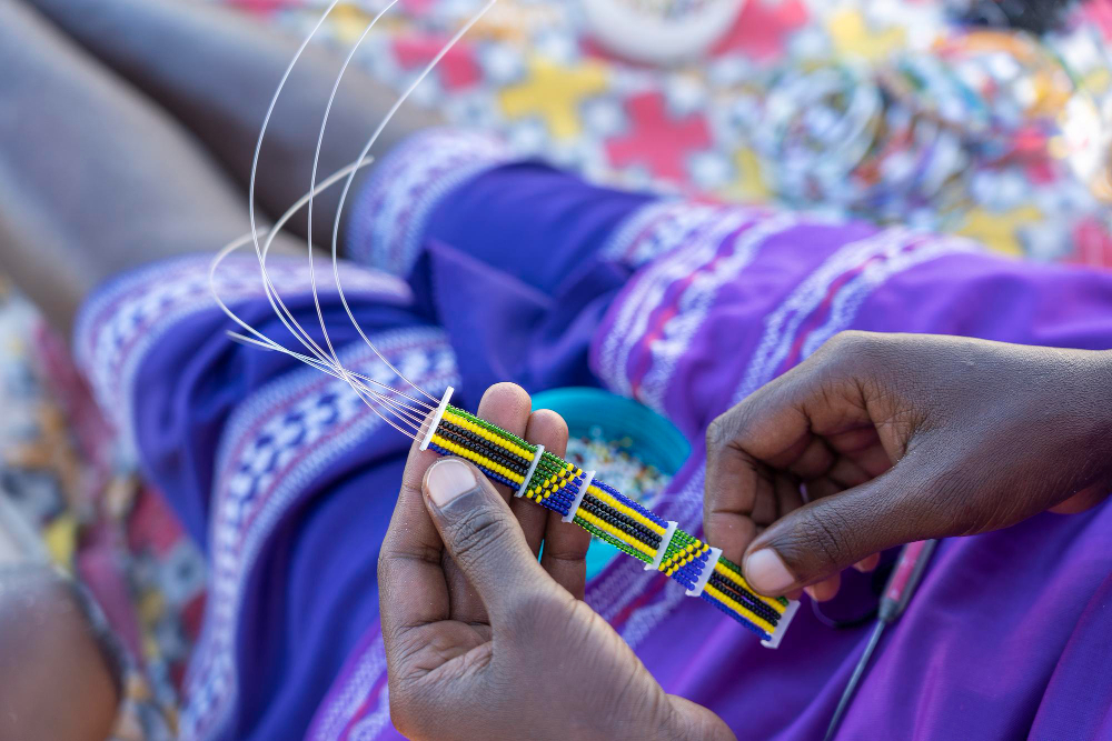 making-handmade-jewellery-masai-african-women-hands-top-view-close-up-island-zanzibar-tanzania-africa